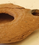 Before, showing the lamp (Inv. Num. 23845) with large crack in the fabric, friable surface and extent of surface loss